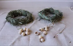 Bunny toys made of hay, string, and large wooden beads